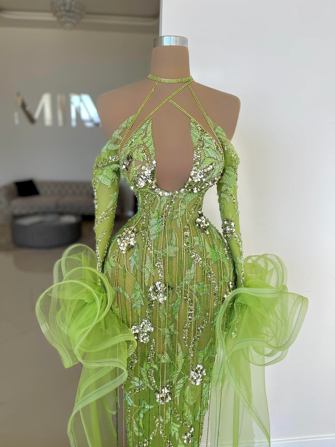 A green dress with glitter on a doll