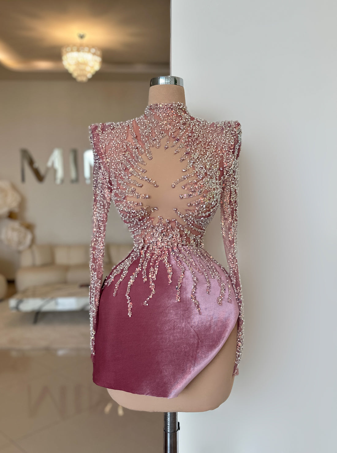 A short, revealing pink dress with crystals on a doll